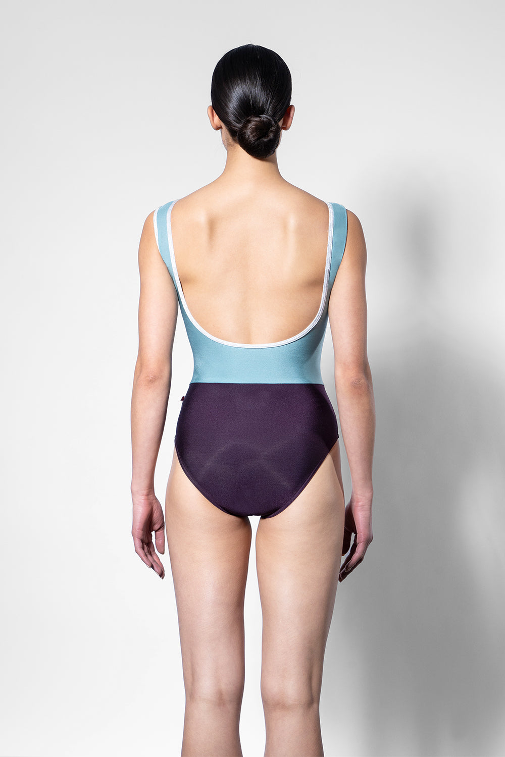 Didi leotard in N-Eggplant body color with N-Cactus top color, N-Silver stripe and CV-Silver trim color