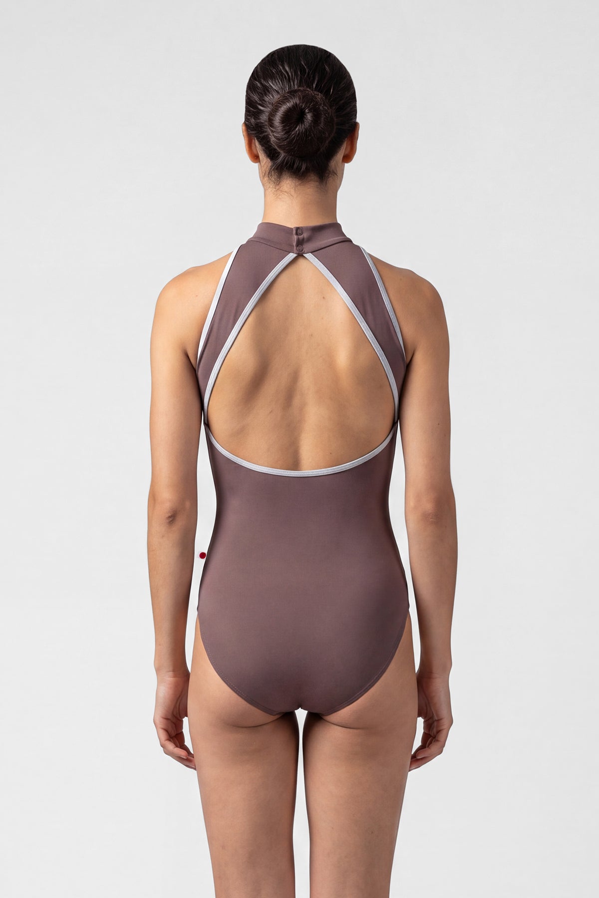 AI-generated model. Noe leotard, mocha-brown with a high halter neck and grey strap trim, open back.
