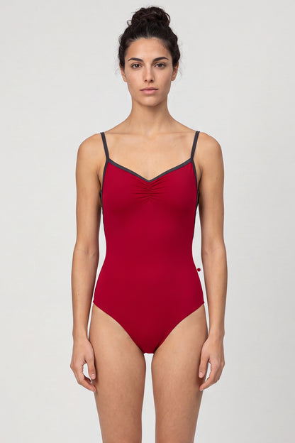 AI-generated model. Tamara leotard, deep crimson with a pinch-front bust, charcoal straps and neckline trim.