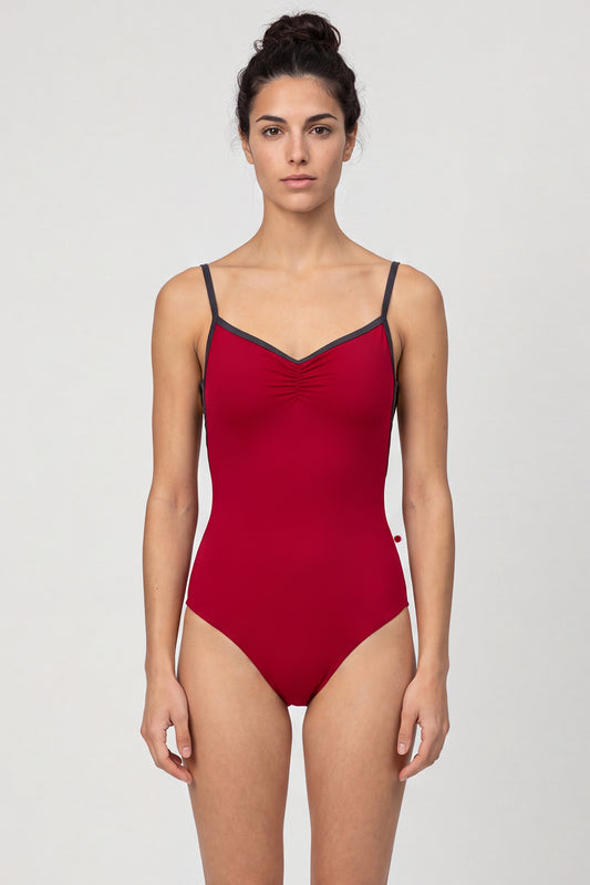 AI-generated model. Tamara leotard, deep crimson with a pinch-front bust, charcoal straps and neckline trim.