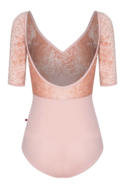 AI-generated model. Elli leotard, blush-pink with a crushed-velvet elbow-sleeve bodice and gathered V-neck.