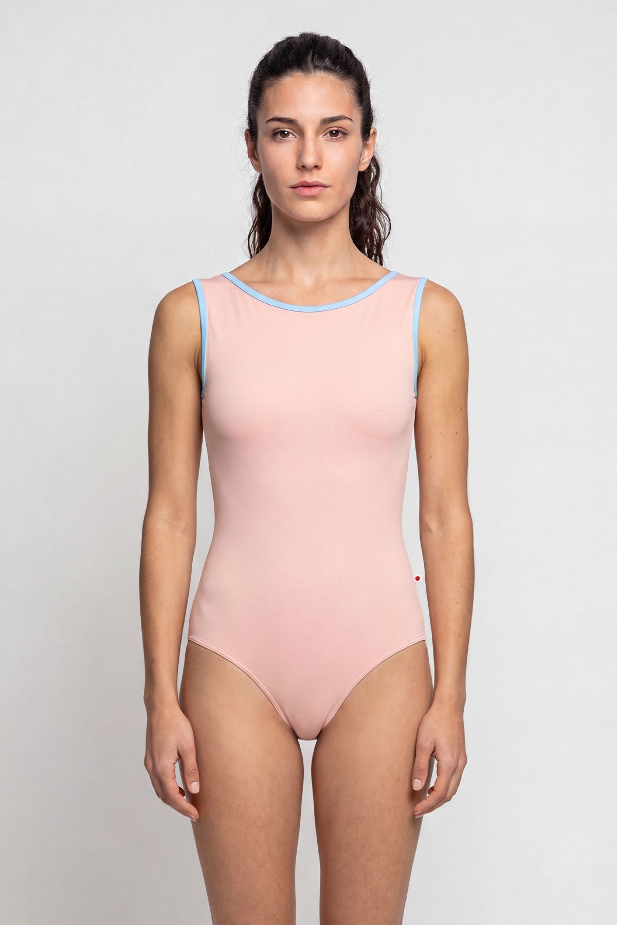 AI-generated model. Sofiane leotard, blush-pink with a contrasting pale-blue neckline trim.