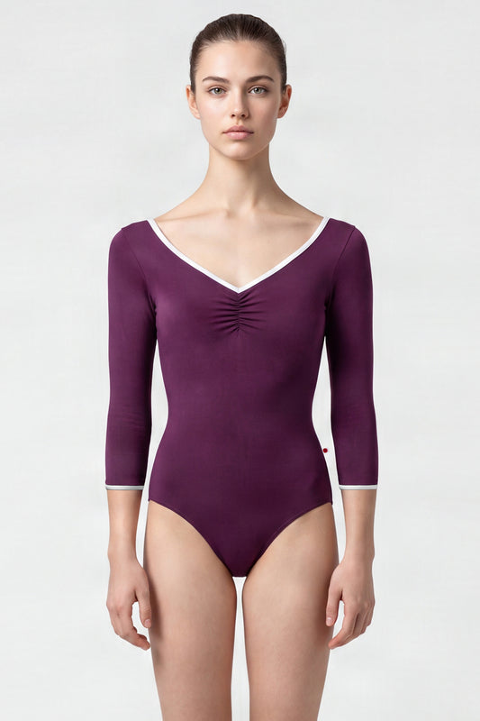 AI-generated model. Anna leotard, aubergine-purple with a ruched V-neck, white trim and three-quarter sleeves.