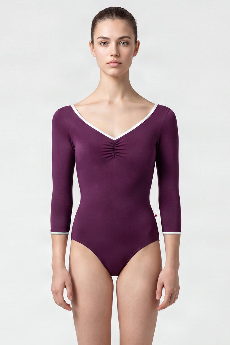 AI-generated model. Anna leotard, aubergine-purple with a ruched V-neck, white trim and three-quarter sleeves.