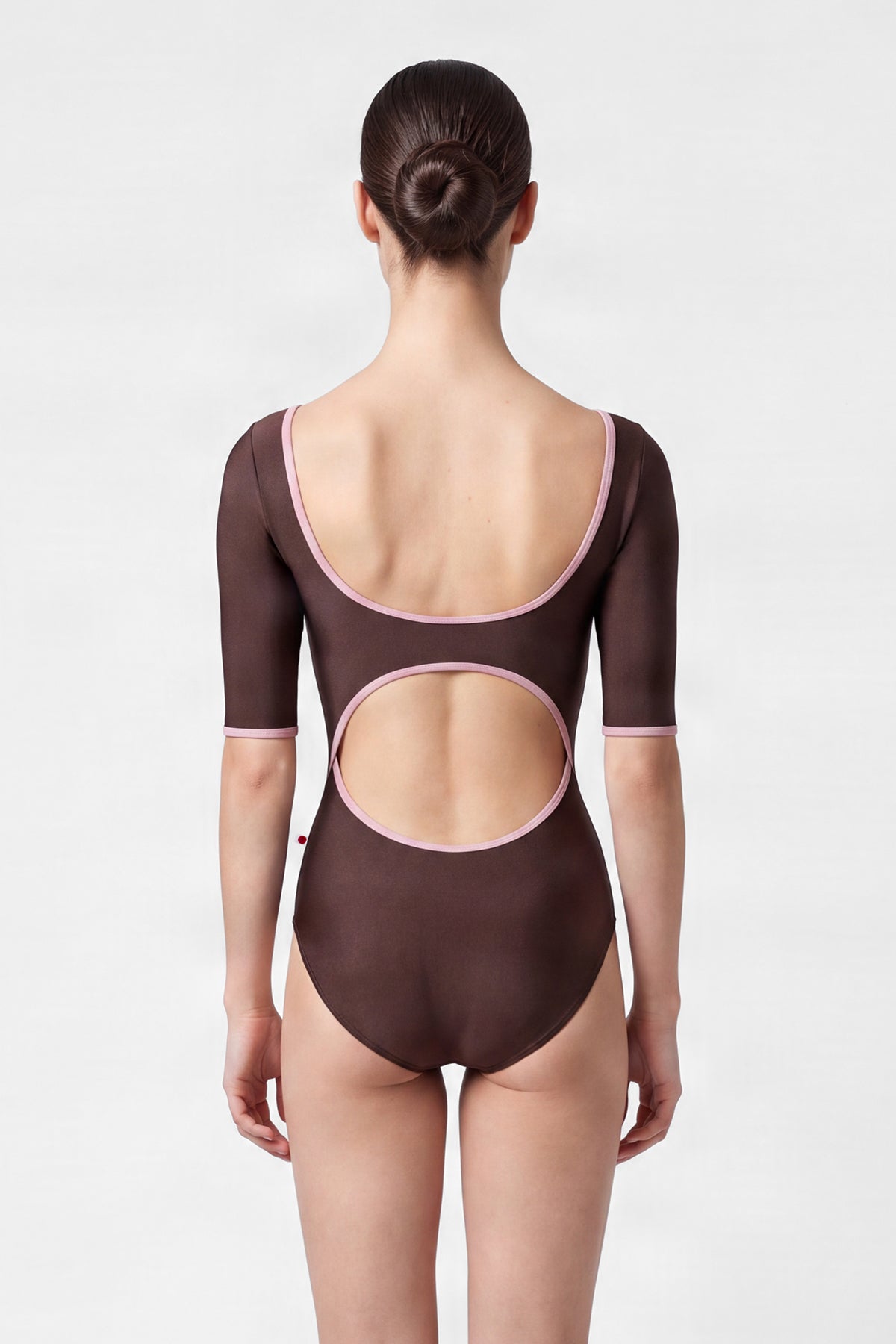 Veronique leotard, mocha-brown with a scoop neck, pink trim and three-quarter sleeves.